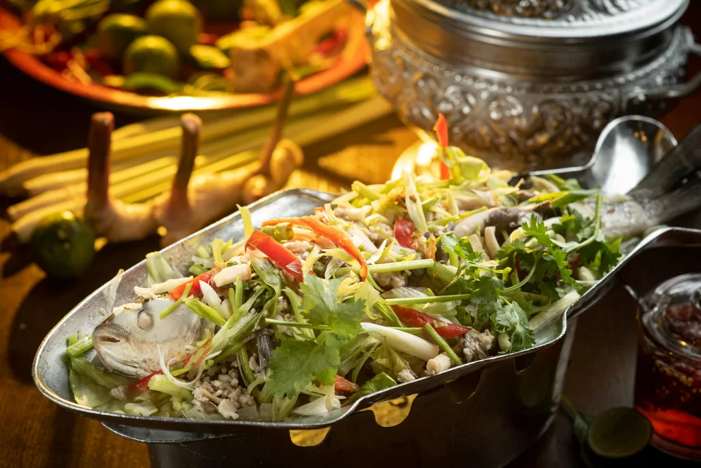 Delicious Thai steamed fish dish garnished with fresh herbs and spices.